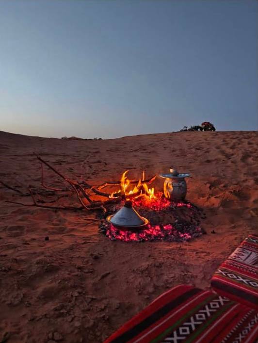 Campfire cooking at dusk